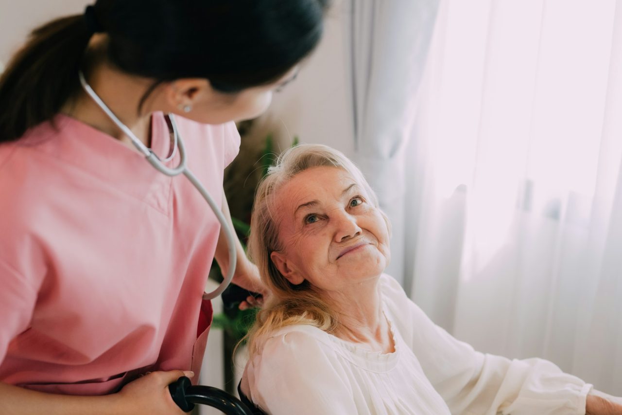 happy senior woman talking with female caregiver.jpg